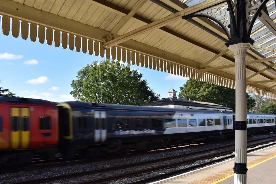 A train under the canopy at Brookwood station