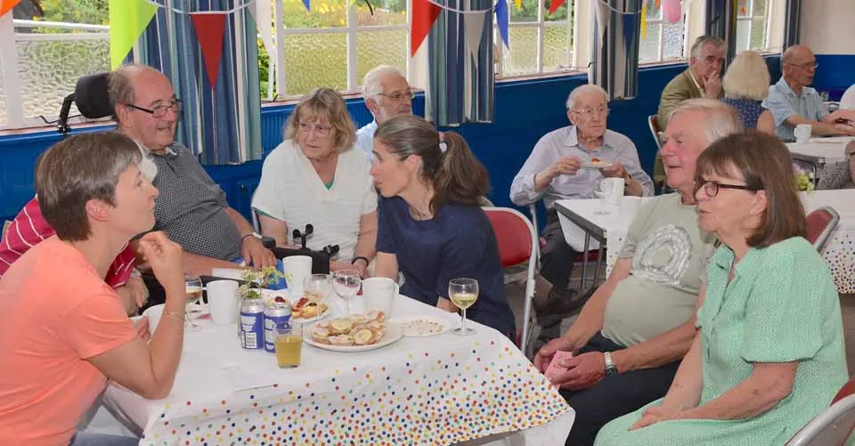 Residents gathered at tables in the hall
